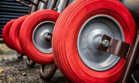 Roues rouges de chariots alignés sur un sol poussiéreux